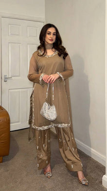 Beige embroidered salwar suit with silver detailing and matching pants for festive and formal occasions