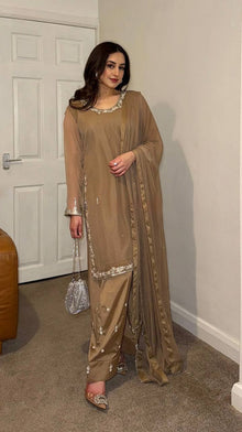 Beige embroidered salwar suit with silver detailing and matching pants for festive and formal occasions