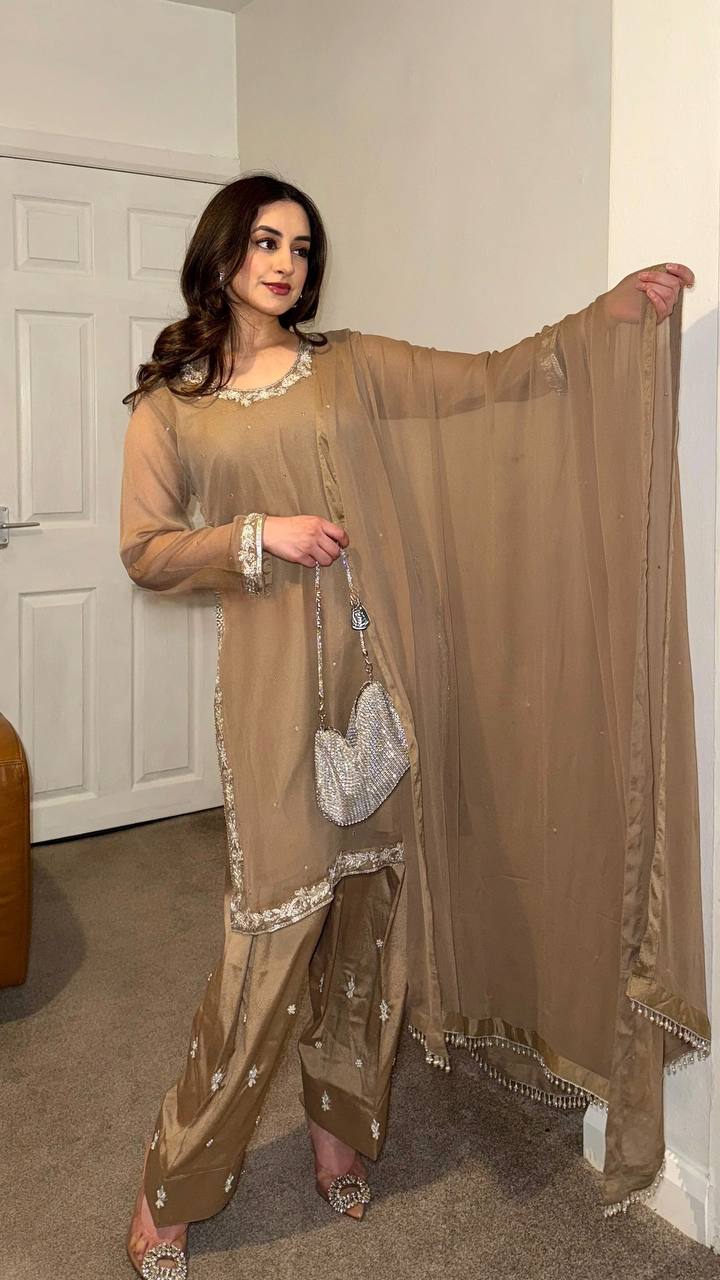 Beige embroidered salwar suit with silver detailing and matching pants for festive and formal occasions