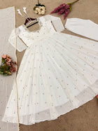 Graceful white anarkali salwar suit with subtle sequin work and dupatta – perfect for festive wear, weddings, or Eid looks.