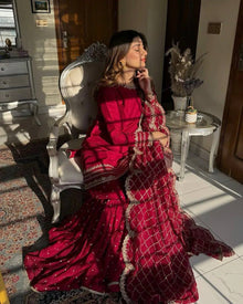 Maroon sharara suit with golden embroidery and net dupatta for weddings and festive occasions