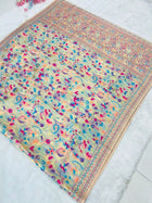 Discover this cream silk saree adorned with multicolor floral print and rich traditional border