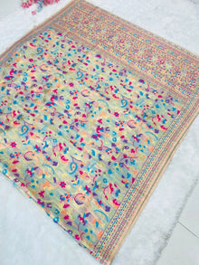 Discover this cream silk saree adorned with multicolor floral print and rich traditional border