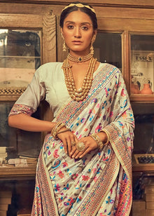 Discover this cream silk saree adorned with multicolor floral print and rich traditional border