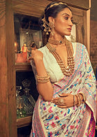 Discover this cream silk saree adorned with multicolor floral print and rich traditional border