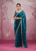 Elegant organza saree with floral embroidered border, perfect for festive events
