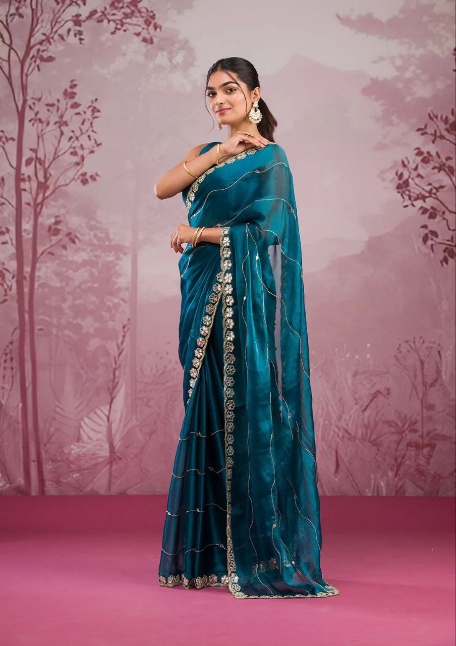 Elegant organza saree with floral embroidered border, perfect for festive events