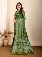 Graceful pure green silk saree with all over Mina Kari weaving and rich zari pallu.