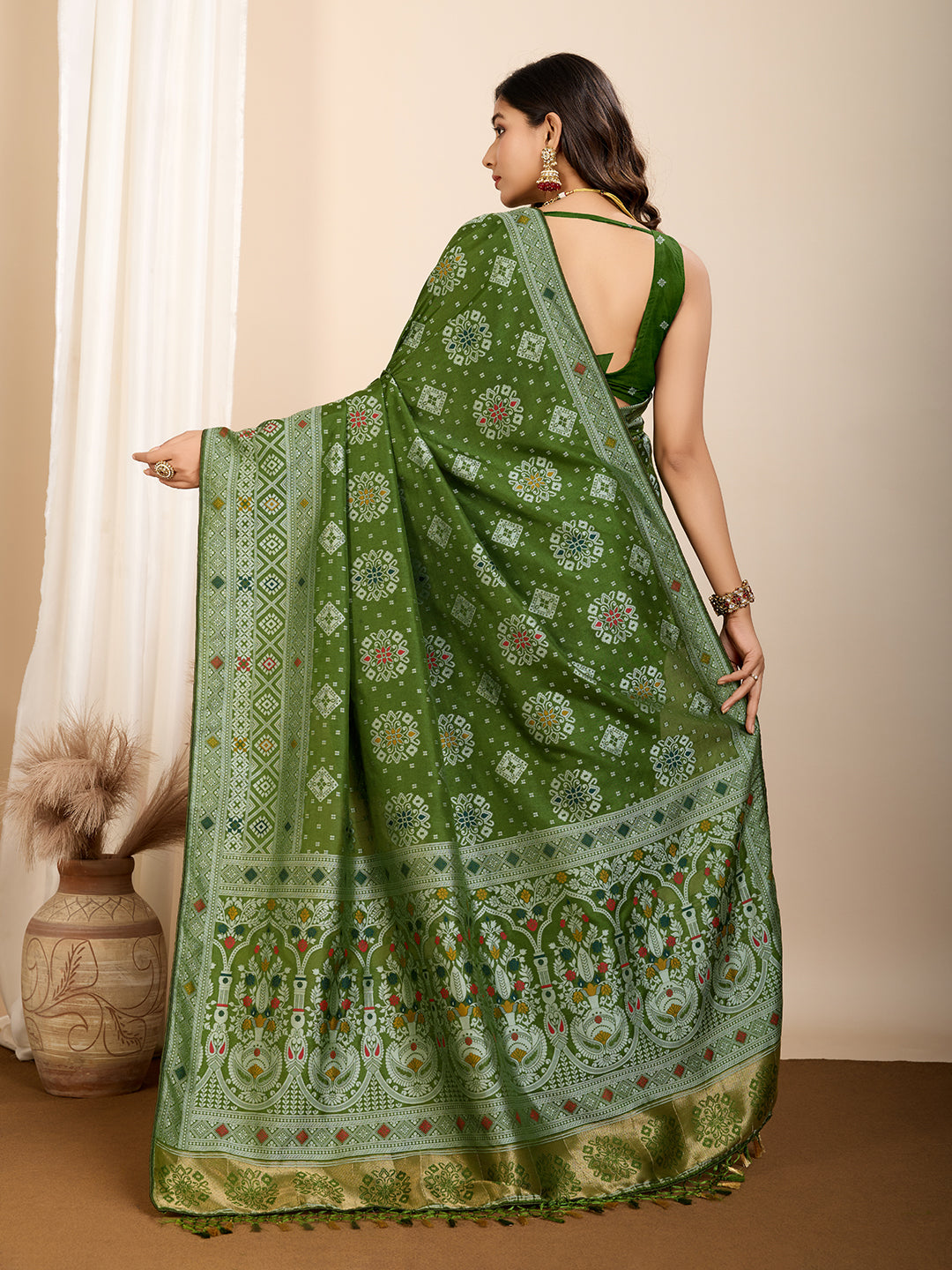 Graceful pure green silk saree with all over Mina Kari weaving and rich zari pallu.