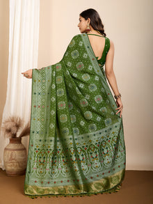Graceful pure green silk saree with all over Mina Kari weaving and rich zari pallu.
