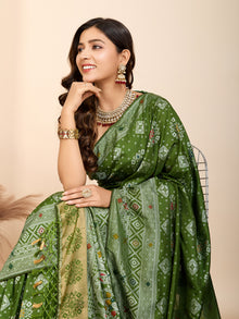 Graceful pure green silk saree with all over Mina Kari weaving and rich zari pallu.