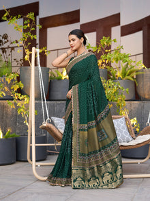 Green cotton saree with all-over table print and foil or lace border. Comes with a contrast blouse Perfect for festive