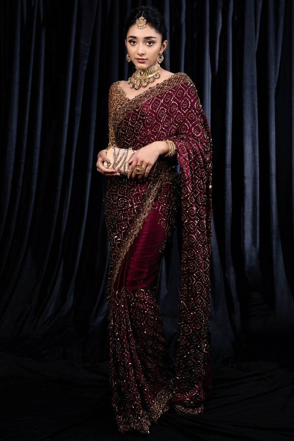 Maroon designer saree with heavy golden sequin embroidery for weddings and festive wear