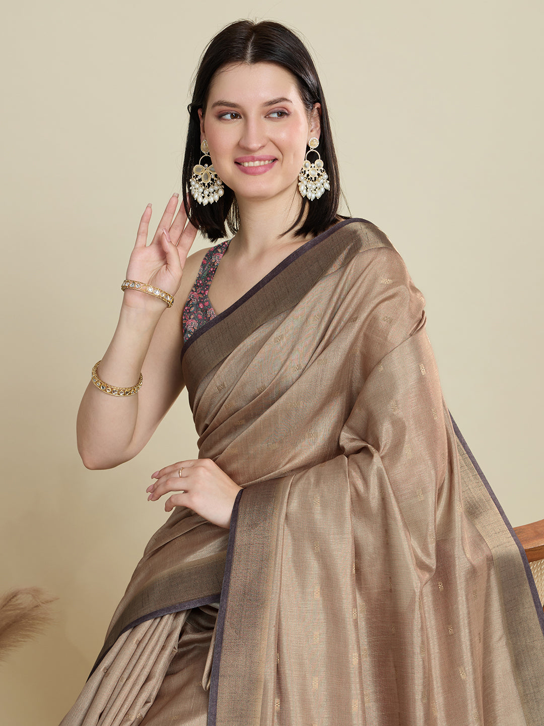 Stylish brown semi cotton saree featuring dancing girl butti, zari border and contrast blouse.