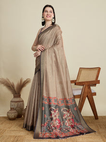 Stylish brown semi cotton saree featuring dancing girl butti, zari border and contrast blouse.