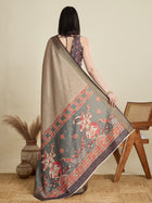 Stylish brown semi cotton saree featuring dancing girl butti, zari border and contrast blouse.