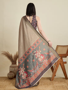 Stylish brown semi cotton saree featuring dancing girl butti, zari border and contrast blouse.