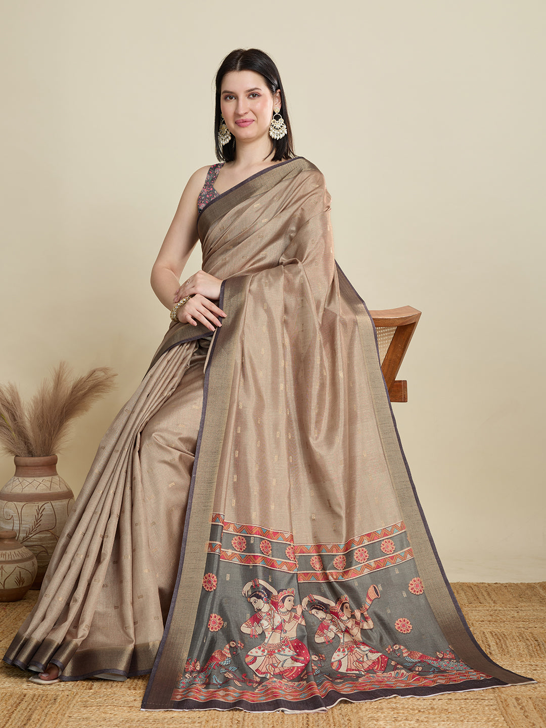 Stylish brown semi cotton saree featuring dancing girl butti, zari border and contrast blouse.